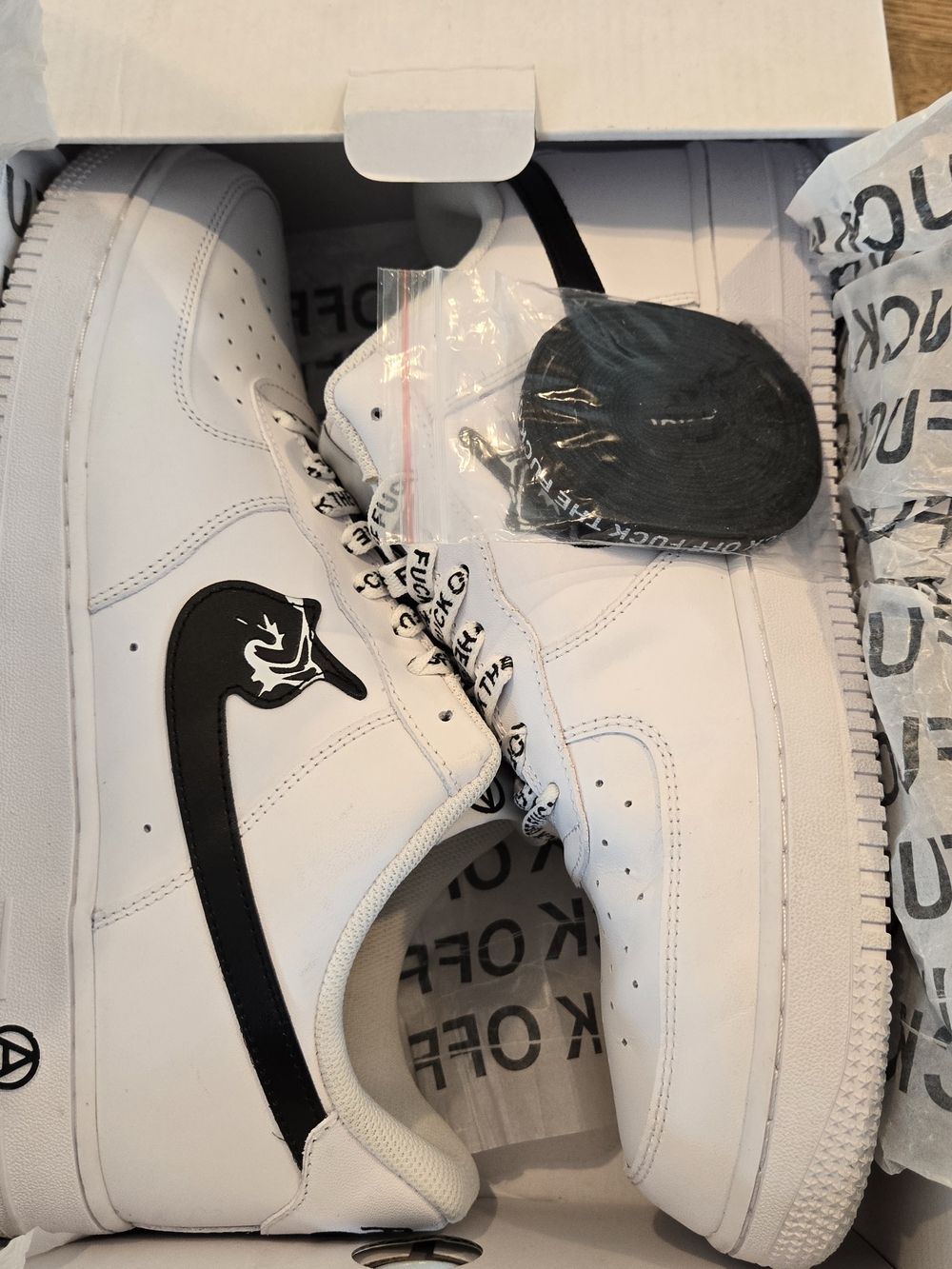 White Low-Top Sneakers with Black Swoosh Accent